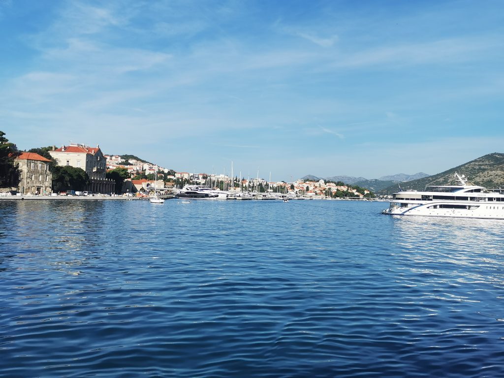 Turquoise waters of the Adriatic sea with the red rooves of the Croatia coastline in the background