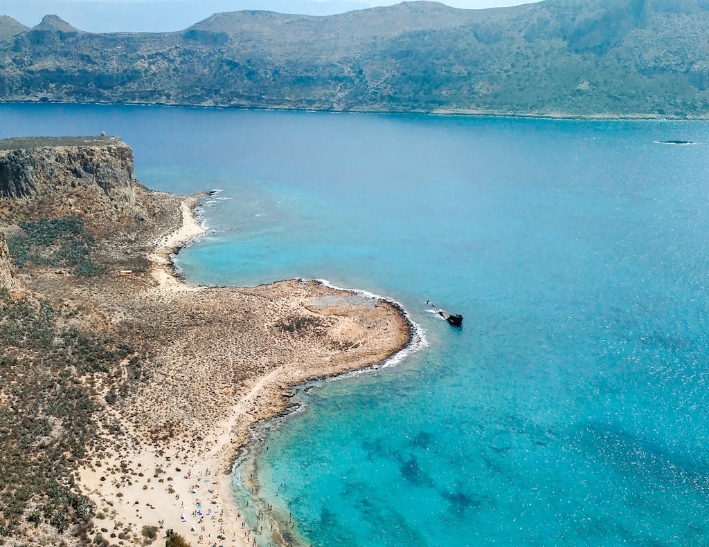 Explore the azure waters and rugged coastline of Balos Beach, Crete from above.