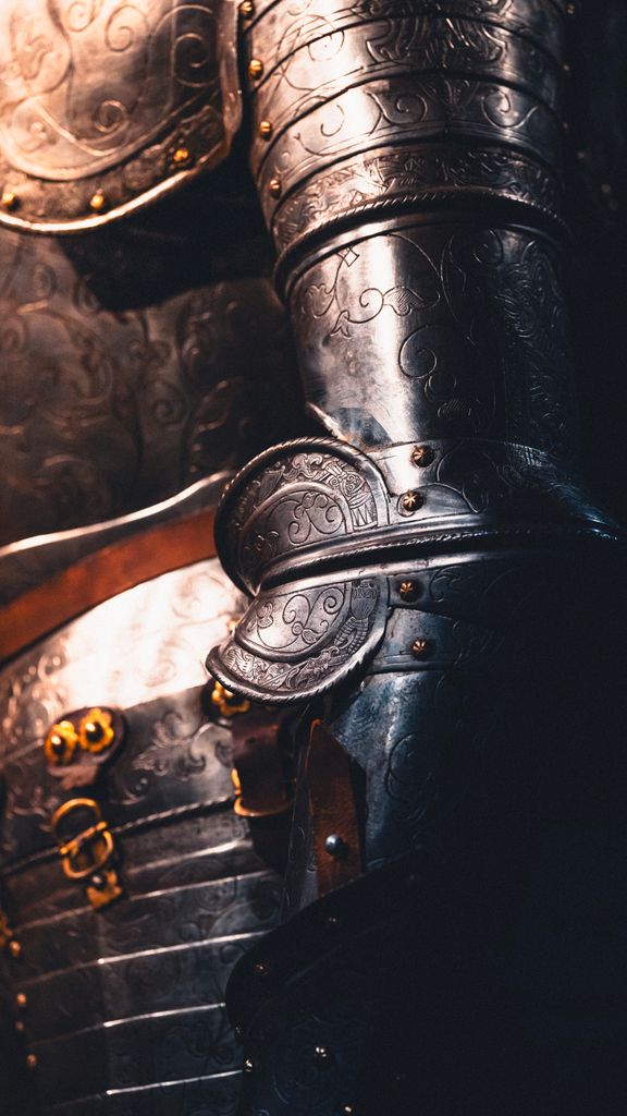 Detailed view of ornate medieval armor showcasing intricate engravings and craftsmanship.