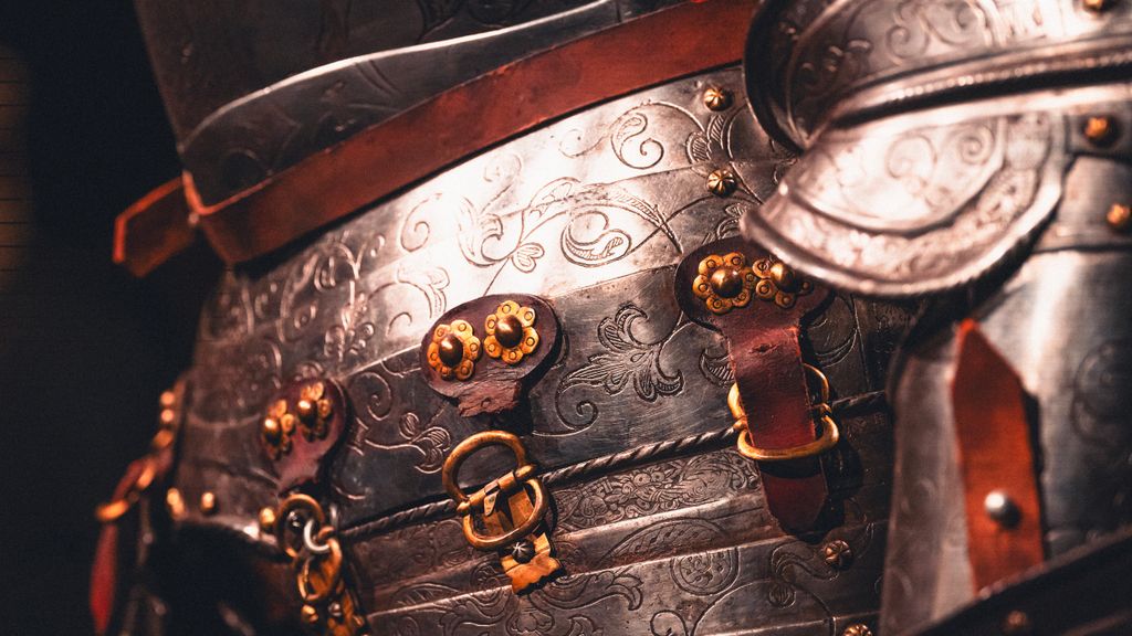 Detailed close-up of intricately designed medieval armour with a belt, representing the belt of the truth of God.