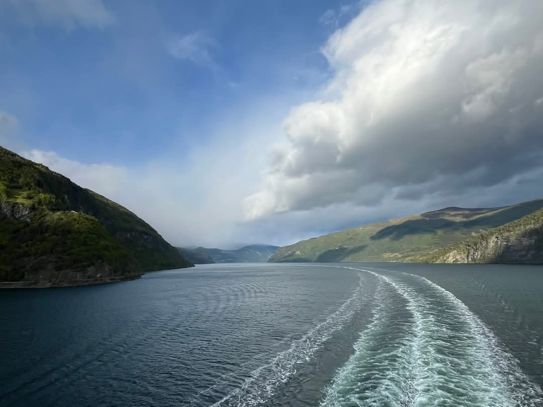 Norfjord in Norway with turquoise blue waters surrounded by lush green mountains