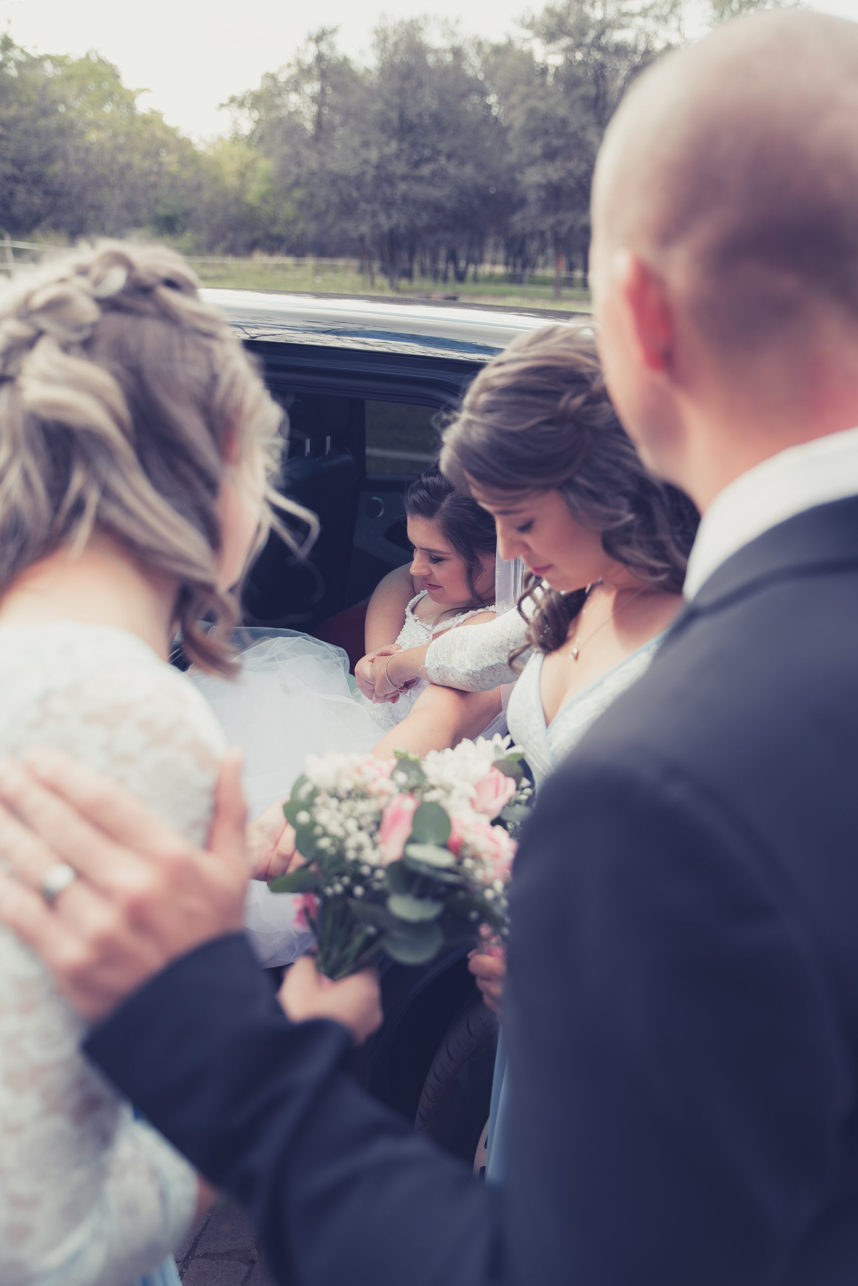 Paster and friends praying over Christian bride on her wedding day