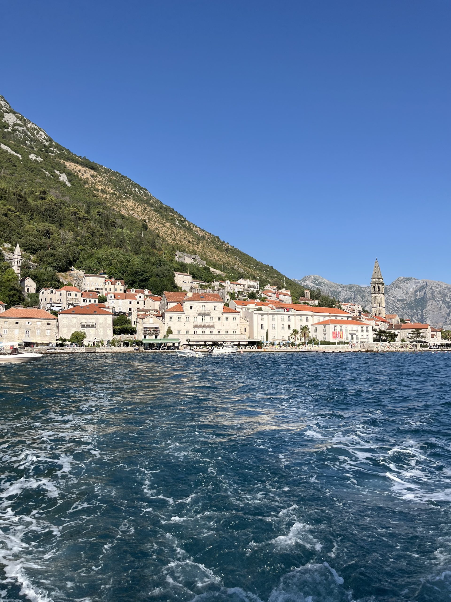 View of Perast from the blue waters of the Bay of Kotor in Montenegro.