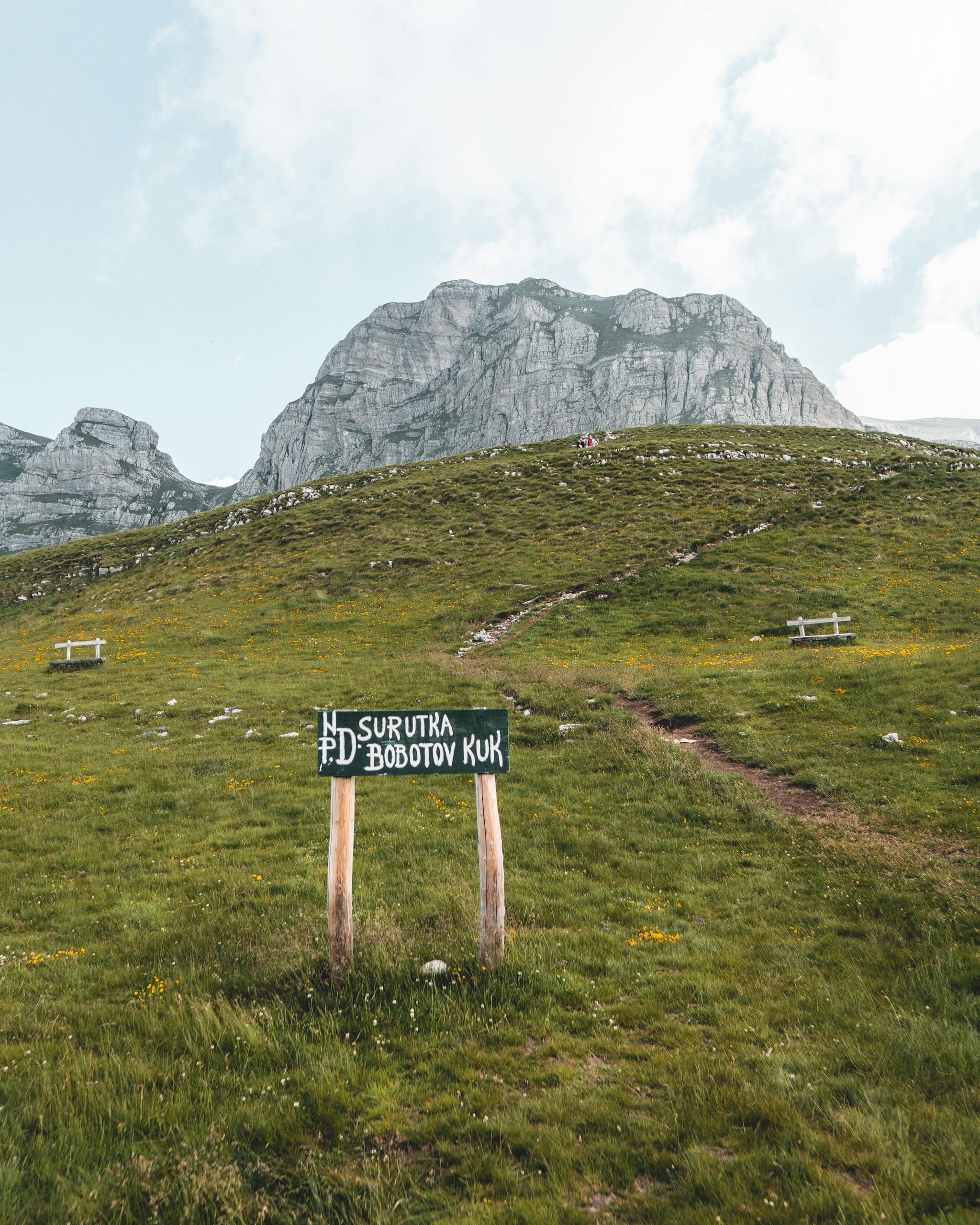 Explore the scenic Bobotov Kuk trail in Montenegro, showcasing lush landscapes and towering mountains.
