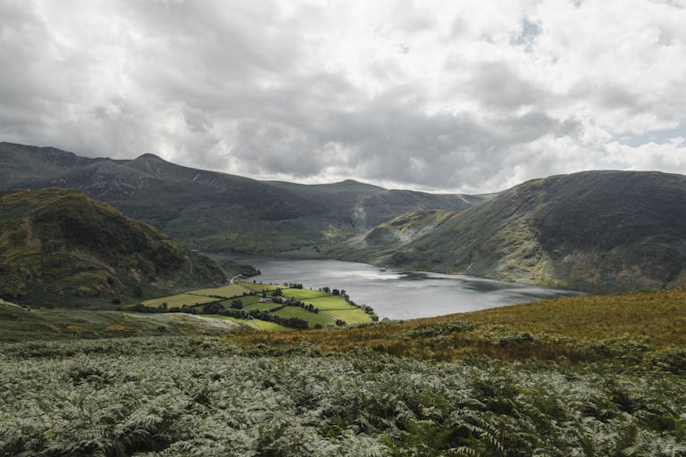 Stunning view of rolling hills and serene lake in England's Lake District.