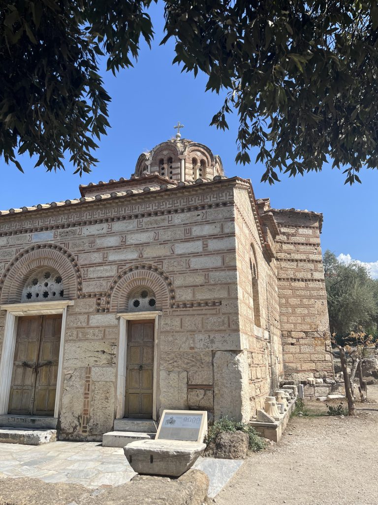 The Church of the Holy Apostles in the Ancient Agora of Athens, with branches of an olive tree in front of it.