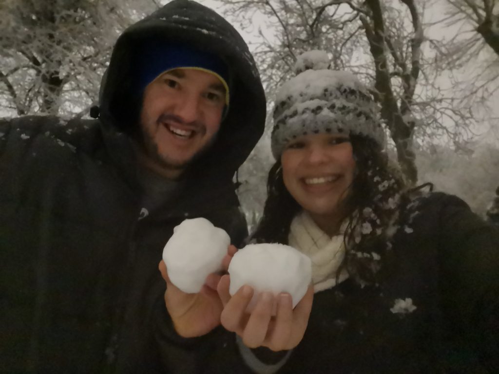 Happy couple having fun in the snow