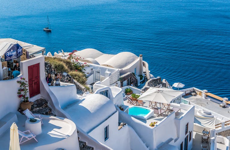 Whitewashed Santorini architecture overlooking the deep blue Aegean Sea.