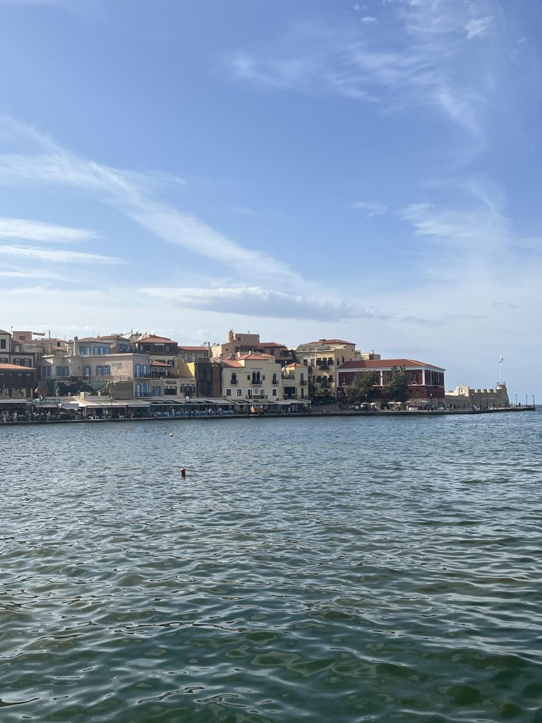 The colourful Venetian Harbour in Chania, Crete with the deep blue sea in front of it.
