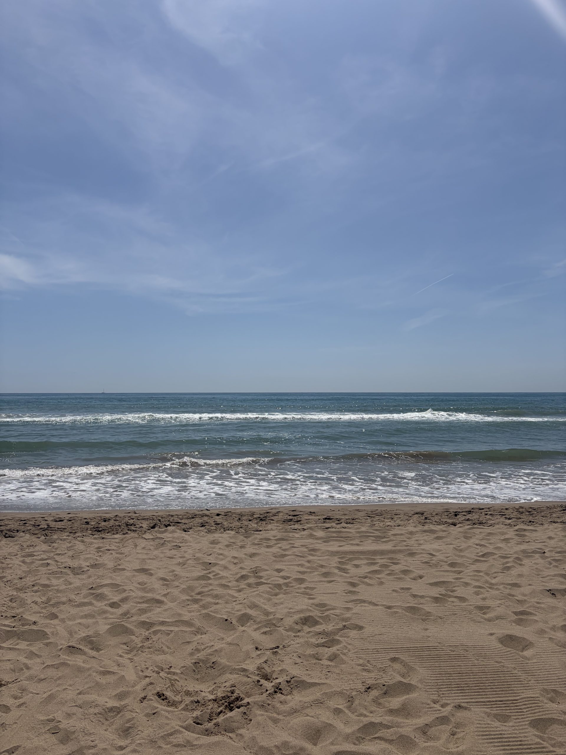 Golden sandy beach with blue skies.