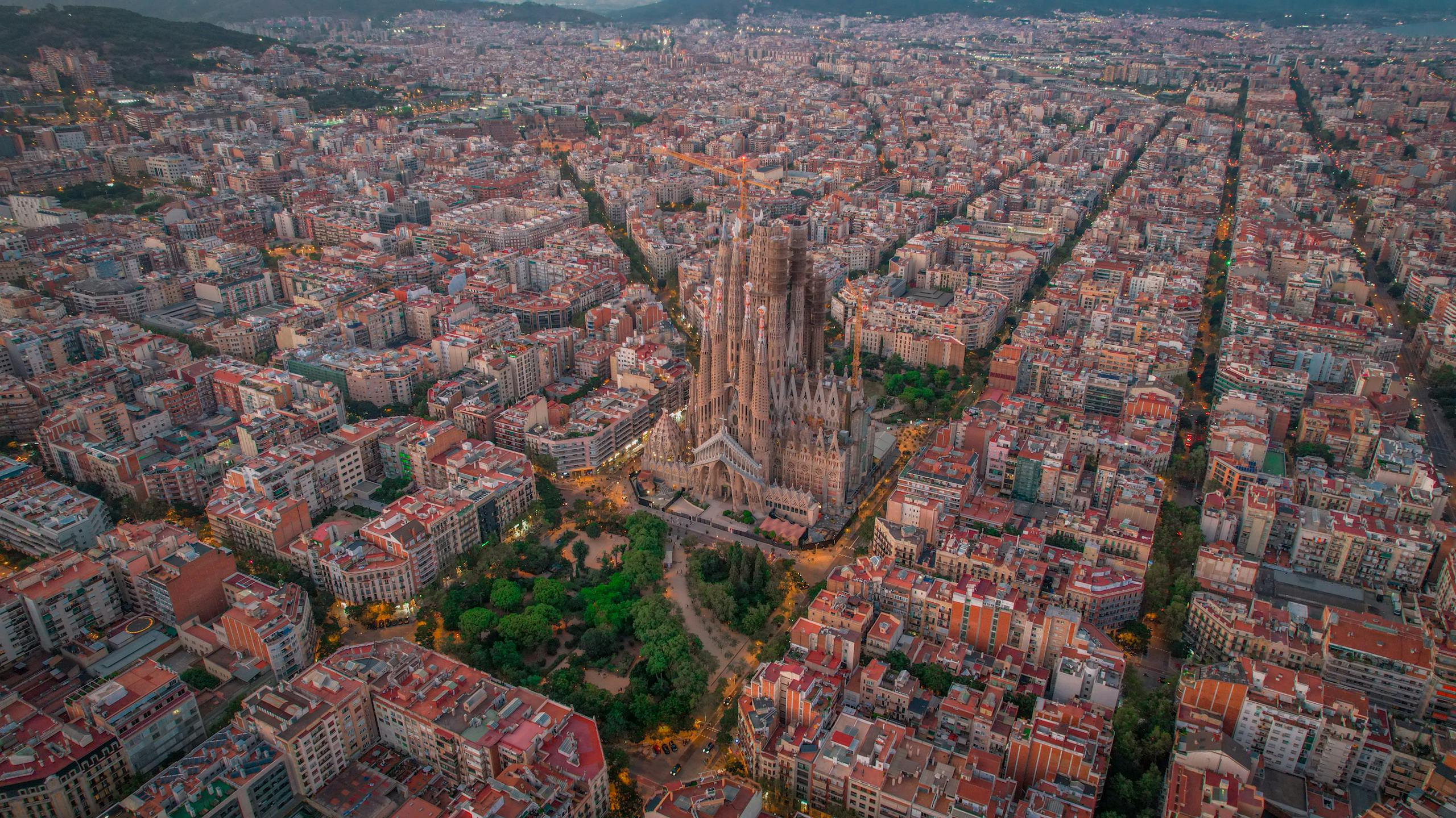Stunning aerial view of the Sagrada Familia amidst the urban landscape of Barcelona, Spain.