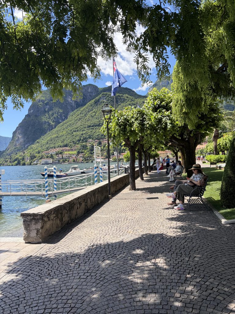 Menaggio lake-side promenade, lined with benches and trees overlooking Lake Como.
