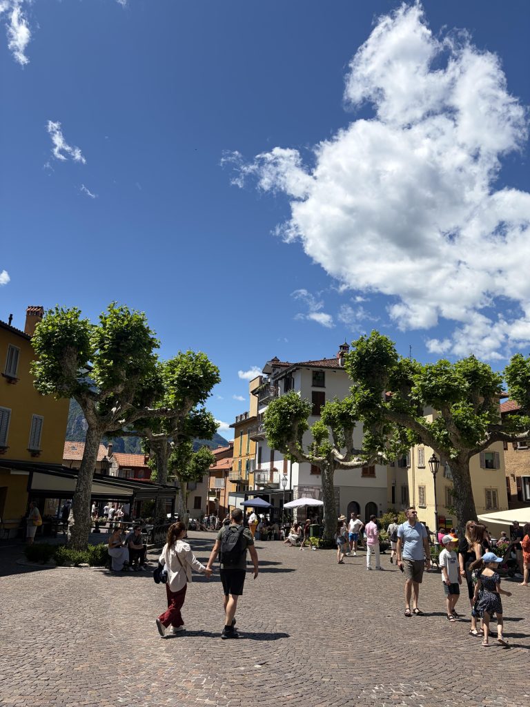 Visitors enjoying the sunshine and views in Piazza San Giorgio, Varenna.