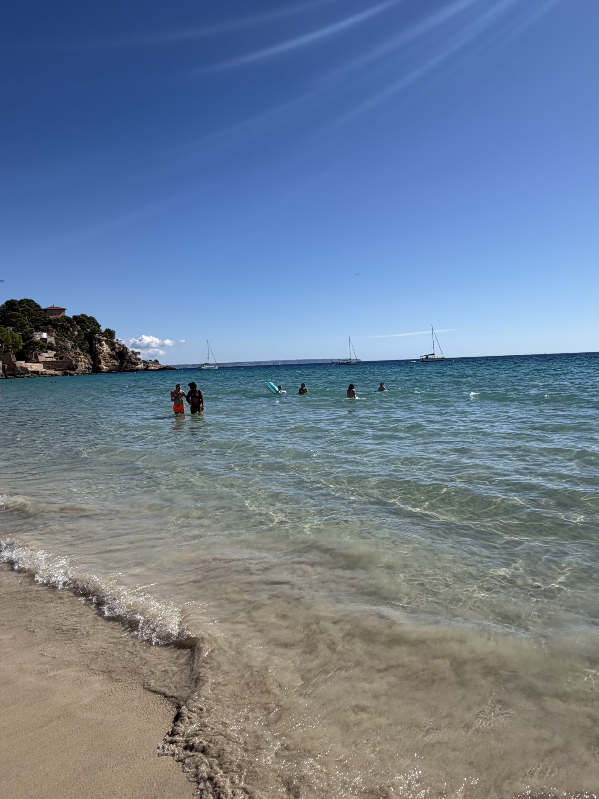 A beautiful golden sandy beach and turquoise sea water in Cala Major, Spain