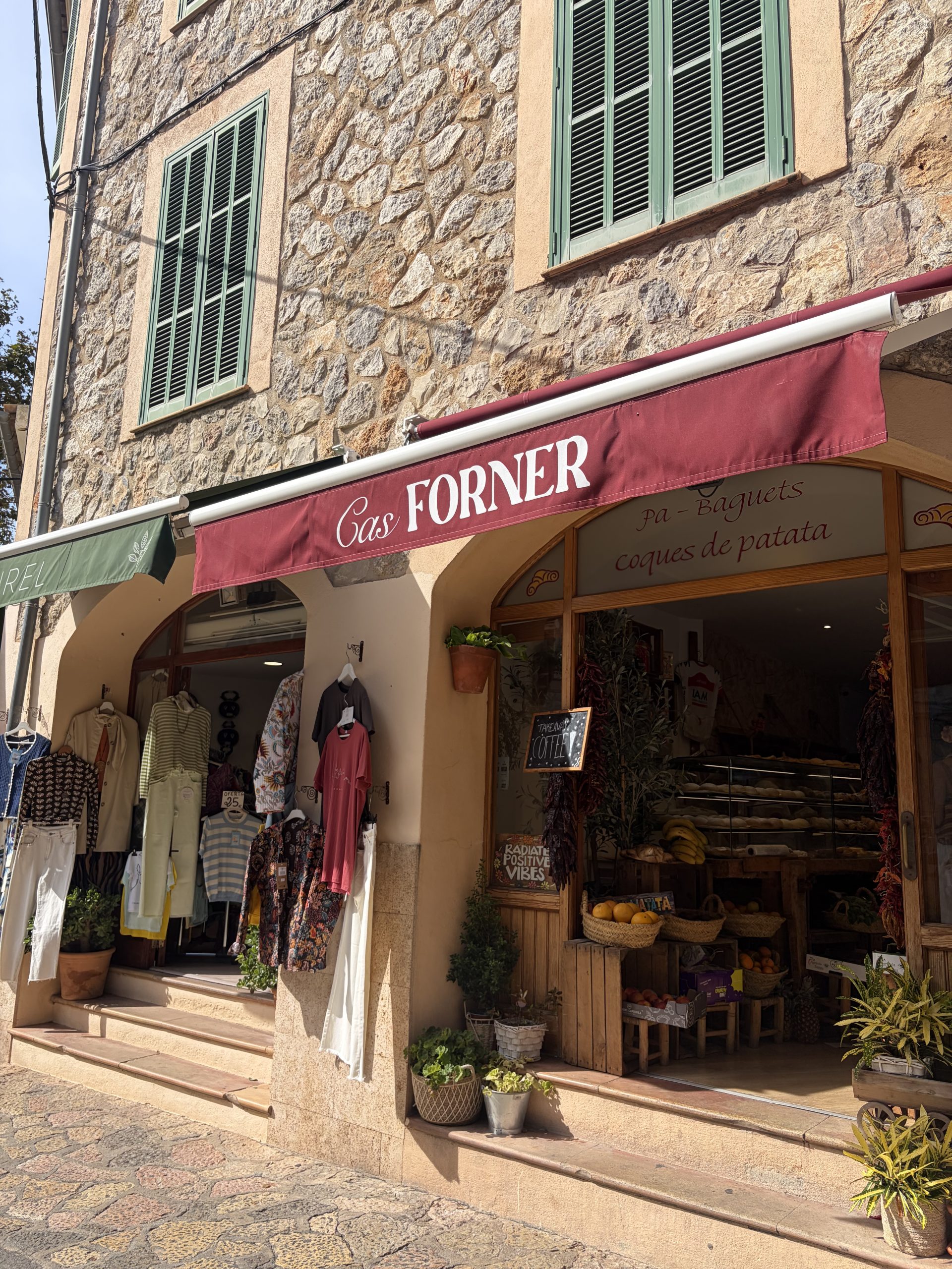 A street in Valldemossa, Mallorca, showing golden-coloured architecture and red shop fronts